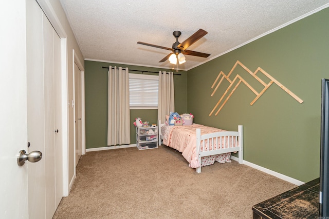 1211 Janwood St, El Dorado, AR 71730 - carpeted bedroom with a textured ceiling, crown molding, baseboards, a ceiling fan, and a closet