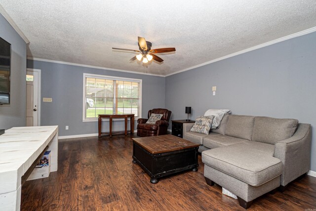 1211 Janwood St, El Dorado, AR 71730 - living room featuring ceiling fan, a textured ceiling, dark wood finished floors, crown molding, and baseboards