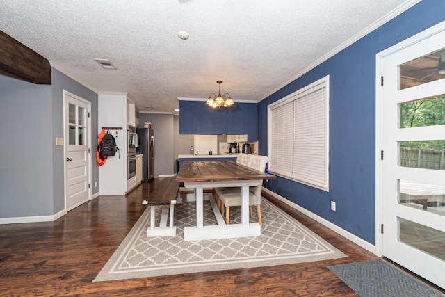 1211 Janwood St, El Dorado, AR 71730 - dining space with a chandelier, a textured ceiling, crown molding, dark wood finished floors, and baseboards