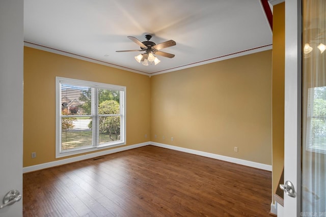 36 Brentwood Cv, Cabot, AR 72023 - spare room featuring ornamental molding, a ceiling fan, dark wood-type flooring, and baseboards