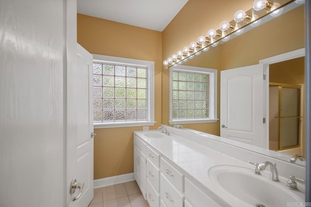 36 Brentwood Cv, Cabot, AR 72023 - bathroom with healthy amount of natural light, double vanity, tile patterned floors, and an enclosed shower