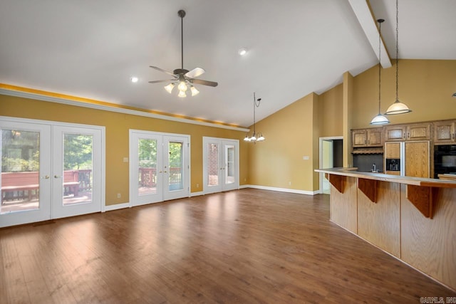 36 Brentwood Cv, Cabot, AR 72023 - kitchen featuring paneled refrigerator, a breakfast bar area, french doors, beam ceiling, and light countertops