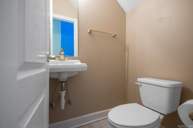 36 Brentwood Cv, Cabot, AR 72023 - half bathroom featuring toilet, tile patterned flooring, and vaulted ceiling