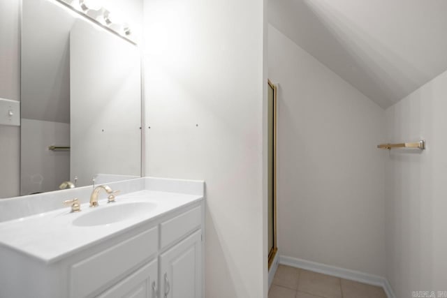 36 Brentwood Cv, Cabot, AR 72023 - full bath featuring vanity, vaulted ceiling, tile patterned floors, baseboards, and a shower with shower door