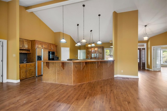 36 Brentwood Cv, Cabot, AR 72023 - kitchen featuring brown cabinets, paneled built in fridge, oven, dark wood finished floors, and high vaulted ceiling