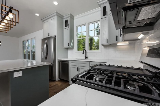 2311 S Louisiana St, Little Rock, AR 72206 - kitchen with stainless steel appliances, a sink, backsplash, decorative light fixtures, and glass insert cabinets