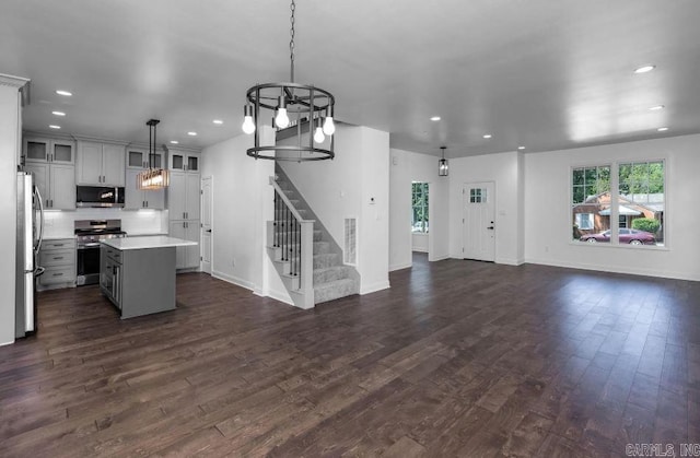 2311 S Louisiana St, Little Rock, AR 72206 - kitchen with appliances with stainless steel finishes, open floor plan, a chandelier, light countertops, and dark wood finished floors