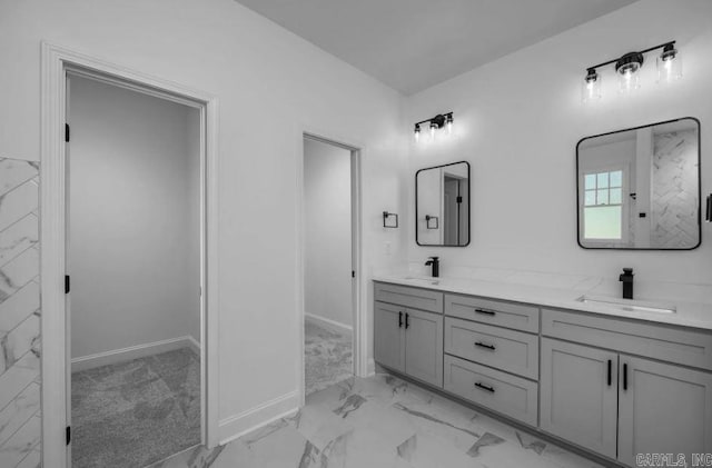 2311 S Louisiana St, Little Rock, AR 72206 - bathroom with marble look tile flooring, double vanity, and baseboards