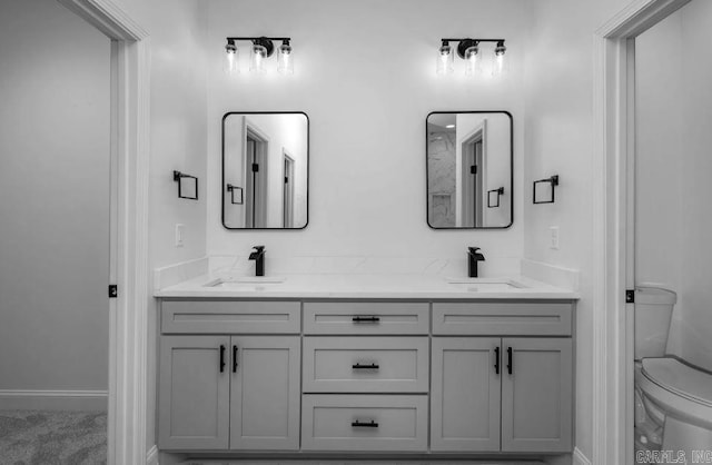 2311 S Louisiana St, Little Rock, AR 72206 - full bathroom with toilet, double vanity, and baseboards