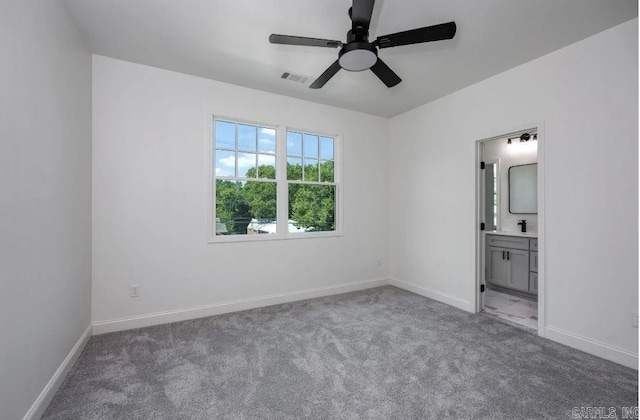 2311 S Louisiana St, Little Rock, AR 72206 - unfurnished bedroom with carpet flooring, baseboards, ensuite bath, and a ceiling fan