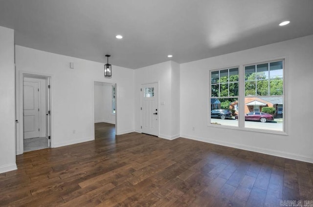 2311 S Louisiana St, Little Rock, AR 72206 - unfurnished living room featuring dark wood-type flooring, baseboards, and recessed lighting