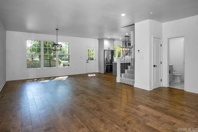 2311 S Louisiana St, Little Rock, AR 72206 - unfurnished living room featuring a chandelier, stairs, dark wood finished floors, baseboards, and recessed lighting