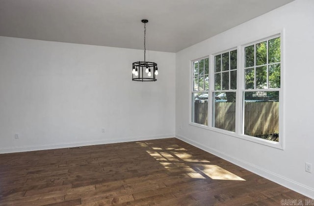 2311 S Louisiana St, Little Rock, AR 72206 - unfurnished dining area featuring a chandelier, plenty of natural light, dark wood-style floors, and baseboards