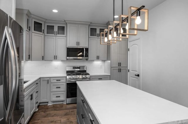 2311 S Louisiana St, Little Rock, AR 72206 - kitchen with appliances with stainless steel finishes, dark wood finished floors, tasteful backsplash, light countertops, and recessed lighting