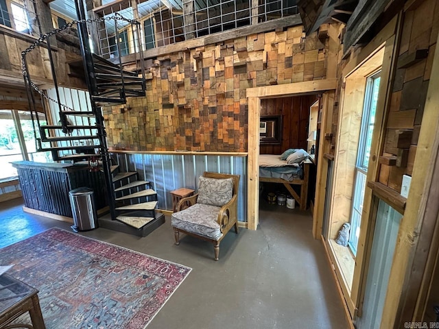675 Nimmo, Searcy, AR 72143 - living area featuring finished concrete floors, stairs, and wood walls