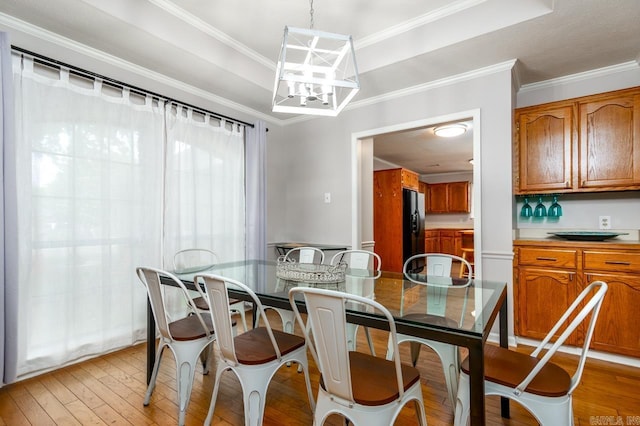 2130 Maplewood Dr, Conway, AR 73034 - dining area featuring light wood-type flooring, a tray ceiling, a chandelier, and ornamental molding
