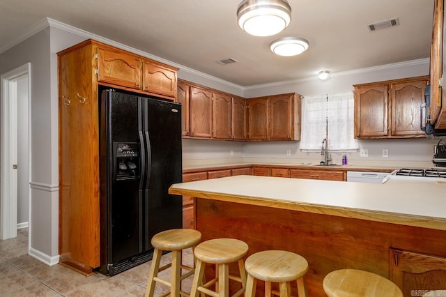 2130 Maplewood Dr, Conway, AR 73034 - kitchen with black refrigerator with ice dispenser, a peninsula, a sink, light countertops, and light tile patterned flooring