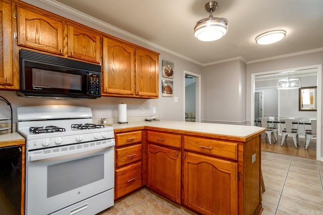 2130 Maplewood Dr, Conway, AR 73034 - kitchen featuring black microwave, white gas range, a peninsula, light tile patterned floors, and light countertops