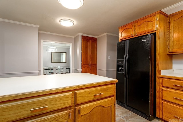 2130 Maplewood Dr, Conway, AR 73034 - kitchen with black fridge, light countertops, brown cabinets, ornamental molding, and light tile patterned floors