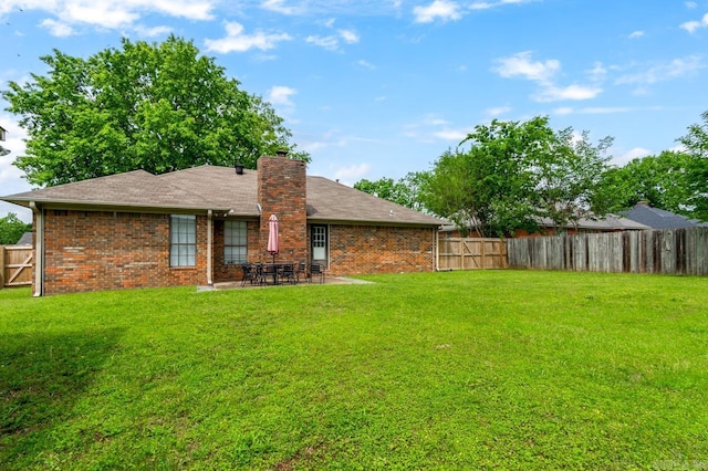 2130 Maplewood Dr, Conway, AR 73034 - back of property featuring a chimney, a patio area, and brick siding