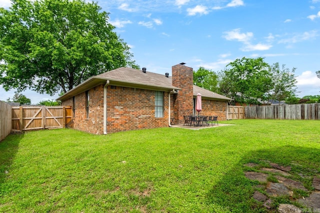 2130 Maplewood Dr, Conway, AR 73034 - rear view of house with a chimney, a patio, brick siding, and a gate