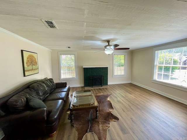 3804 Ridge Rd, North Little Rock, AR 72116 - living area featuring wood finished floors, a fireplace with flush hearth, crown molding, a ceiling fan, and baseboards