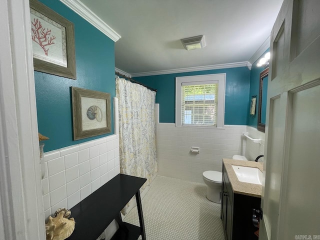 3804 Ridge Rd, North Little Rock, AR 72116 - bathroom with tile walls, toilet, vanity, wainscoting, and crown molding