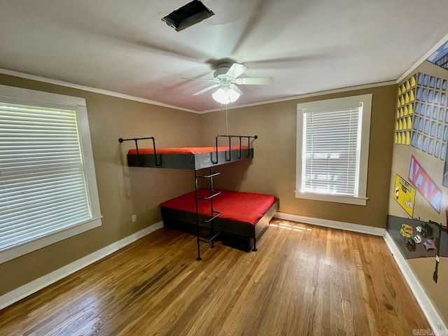 3804 Ridge Rd, North Little Rock, AR 72116 - bedroom with baseboards, wood finished floors, ornamental molding, multiple windows, and ceiling fan
