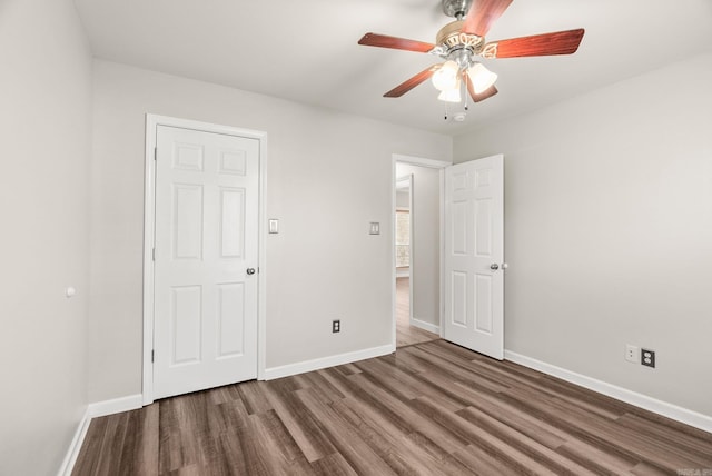 8001 Mars Hill Rd, Bauxite, AR 72011 - unfurnished bedroom featuring wood finished floors, baseboards, and a ceiling fan