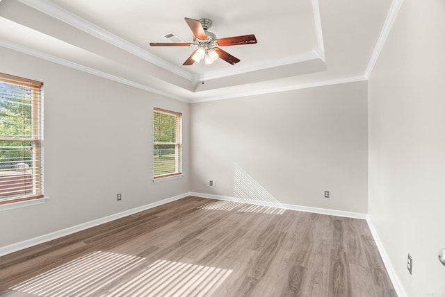 8001 Mars Hill Rd, Bauxite, AR 72011 - unfurnished room featuring a raised ceiling, ceiling fan, light wood-style flooring, baseboards, and crown molding