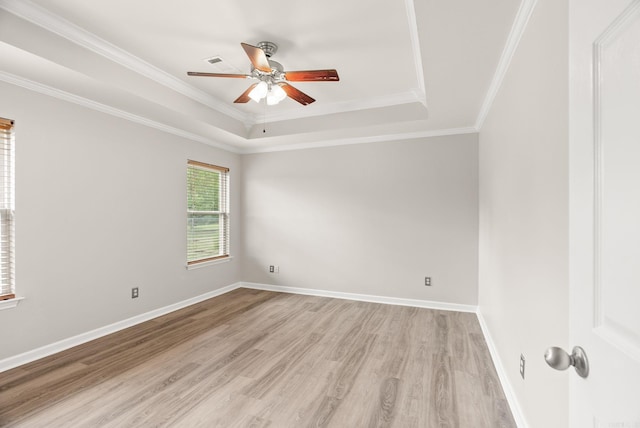 8001 Mars Hill Rd, Bauxite, AR 72011 - unfurnished room featuring a tray ceiling, light wood-type flooring, ceiling fan, crown molding, and baseboards
