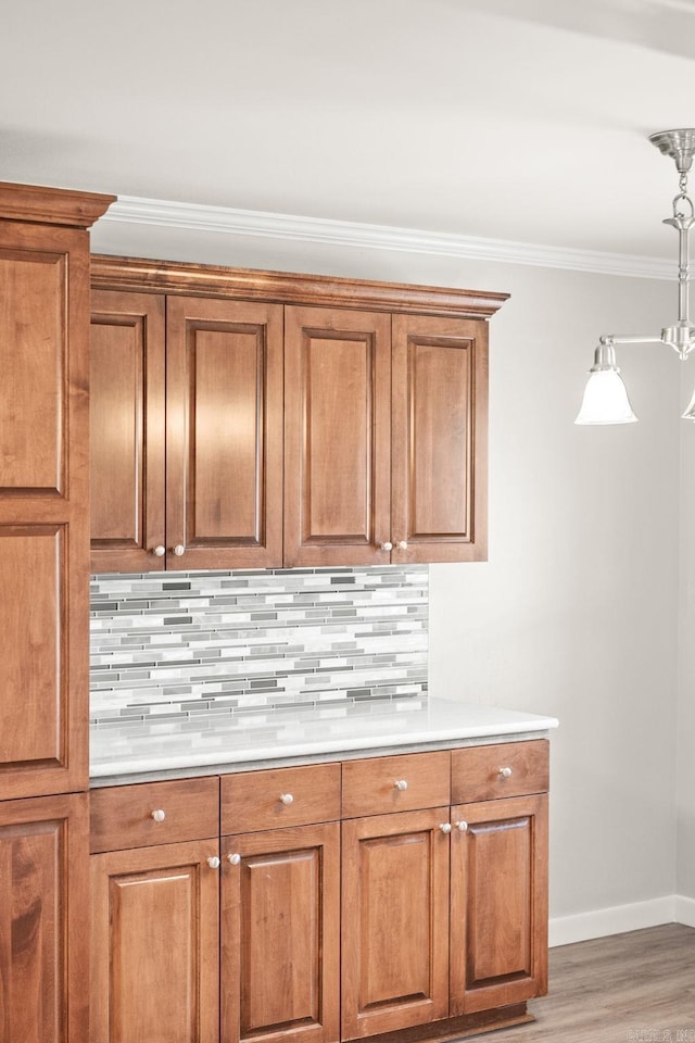 8001 Mars Hill Rd, Bauxite, AR 72011 - kitchen featuring brown cabinets, baseboards, decorative backsplash, crown molding, and light wood-type flooring