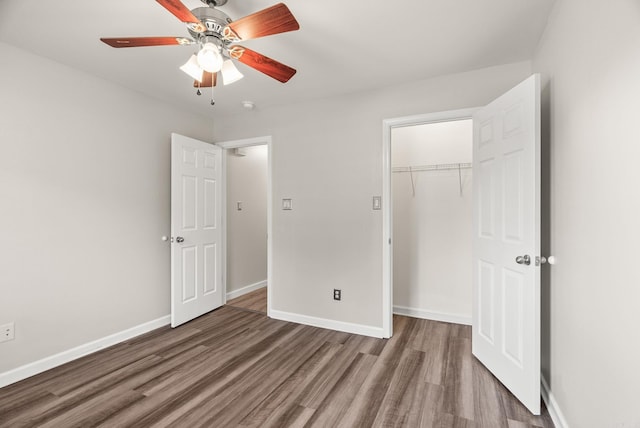 8001 Mars Hill Rd, Bauxite, AR 72011 - unfurnished bedroom featuring wood finished floors, a closet, baseboards, and ceiling fan
