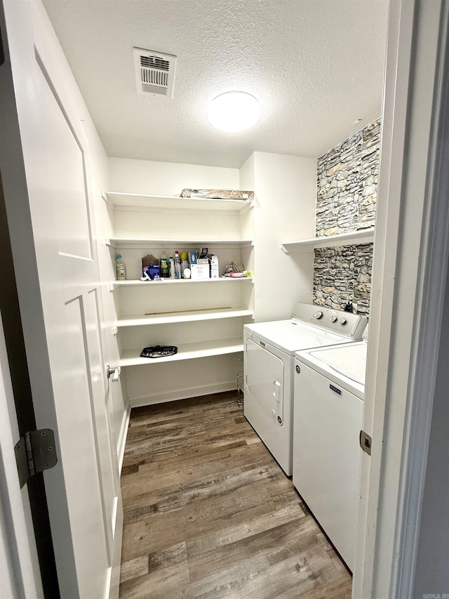 604 Samuel Loyce Dr, Searcy, AR 72143 - laundry area featuring washer and clothes dryer, wood finished floors, and a textured ceiling