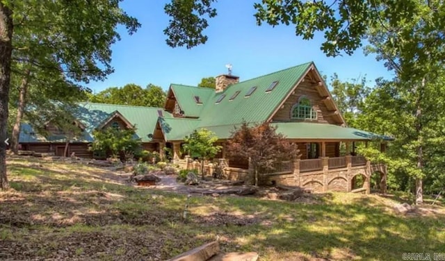 10836 Bray Rd, Elkins, AR 72727 - back of property with a chimney, metal roof, and stone siding