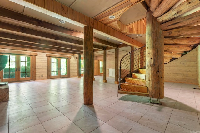 10836 Bray Rd, Elkins, AR 72727 - basement featuring wooden walls, stairs, tile patterned flooring, and french doors