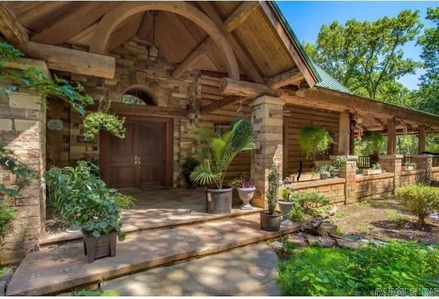 10836 Bray Rd, Elkins, AR 72727 - view of exterior entry featuring log exterior and stone siding