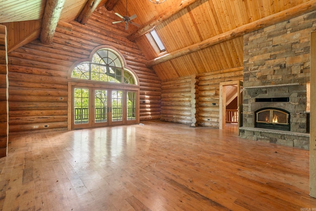 10836 Bray Rd, Elkins, AR 72727 - unfurnished living room with high vaulted ceiling, a skylight, log walls, wood-type flooring, and ceiling fan