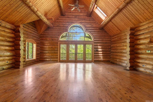 10836 Bray Rd, Elkins, AR 72727 - unfurnished living room featuring wooden ceiling with exposed beams, wood-type flooring, ceiling fan, high vaulted ceiling, and rustic walls