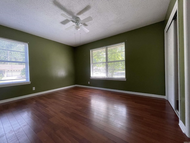101 Chula Vista Rd, El Dorado Springs, AR 71730 - spare room with a textured ceiling, dark wood finished floors, ceiling fan, and baseboards