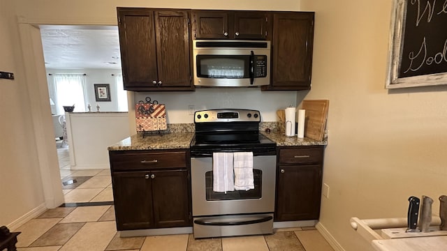 21 Sharp St, Ash Flat, AR 72513 - kitchen with appliances with stainless steel finishes, light tile patterned floors, and dark brown cabinetry