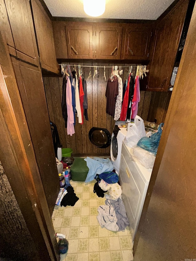 4109 Garrison Rd, Little Rock, AR 72223 - laundry area featuring washer and dryer, wood walls, cabinet space, and tile patterned floors