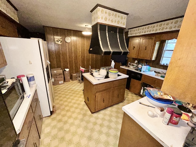 4109 Garrison Rd, Little Rock, AR 72223 - kitchen featuring light floors, wooden walls, light countertops, a center island, and brown cabinets