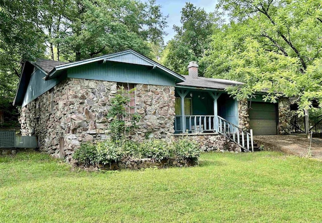 4109 Garrison Rd, Little Rock, AR 72223 - view of front of home with stone siding, a garage, a chimney, and a front lawn