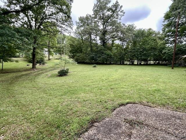 4109 Garrison Rd, Little Rock, AR 72223 - view of grassy yard with view of wooded area