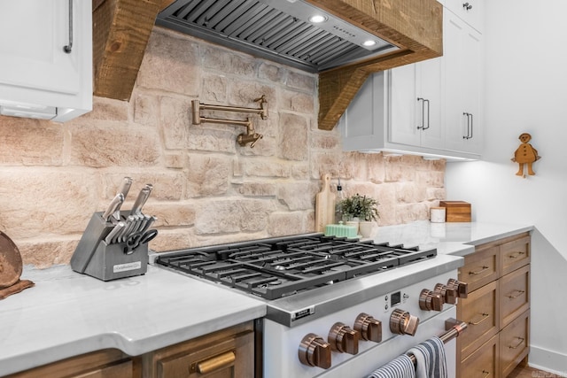 2995 Cresthaven St, Conway, AR 72034 - kitchen featuring high end stove, custom range hood, backsplash, light countertops, and white cabinetry