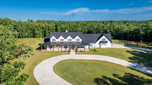 2995 Cresthaven St, Conway, AR 72034 - view of front of property featuring curved driveway, a wooded view, a porch, and a front lawn