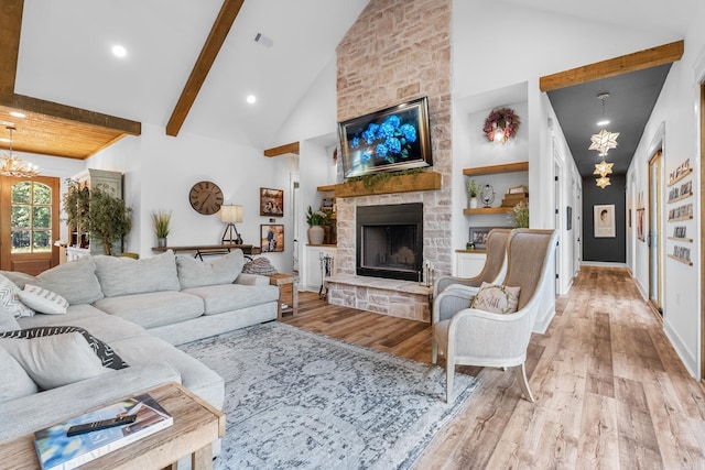 2995 Cresthaven St, Conway, AR 72034 - living room with a chandelier, wood finished floors, a stone fireplace, high vaulted ceiling, and beam ceiling