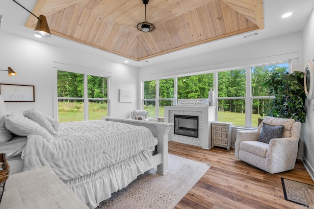 2995 Cresthaven St, Conway, AR 72034 - bedroom with wood finished floors, a tile fireplace, and recessed lighting