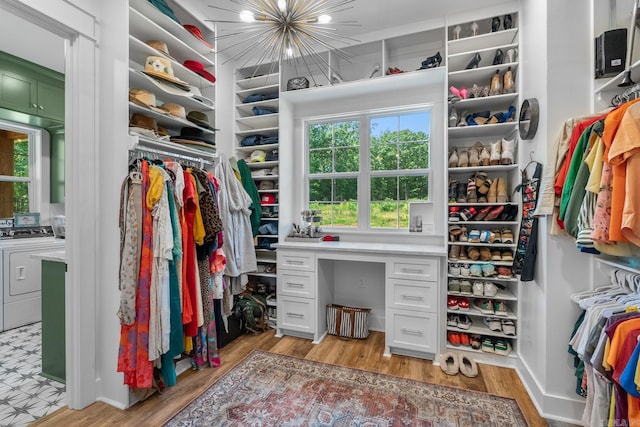 2995 Cresthaven St, Conway, AR 72034 - walk in closet with washing machine and clothes dryer, light wood-type flooring, and a chandelier